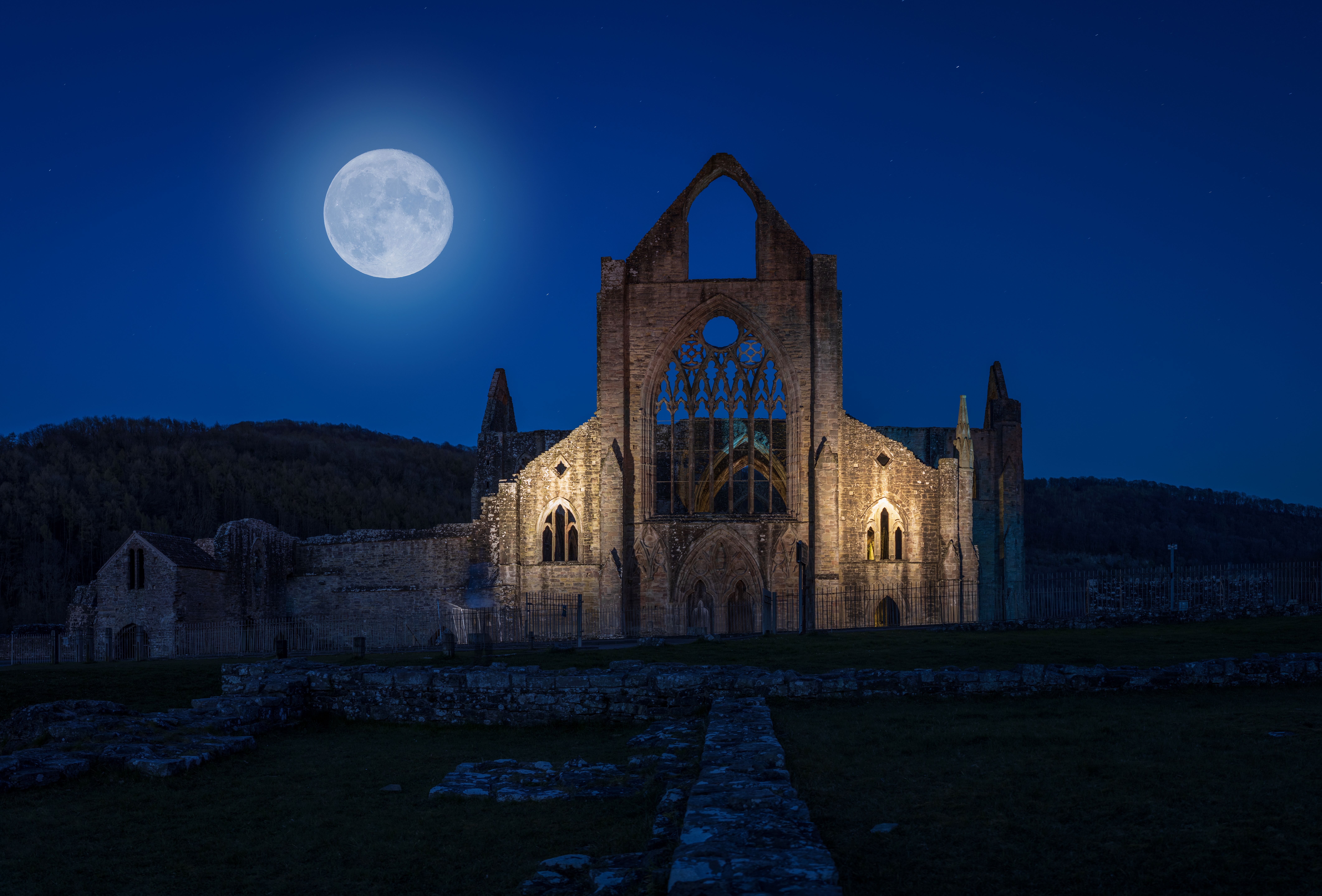 Moon rising over tintern abbey